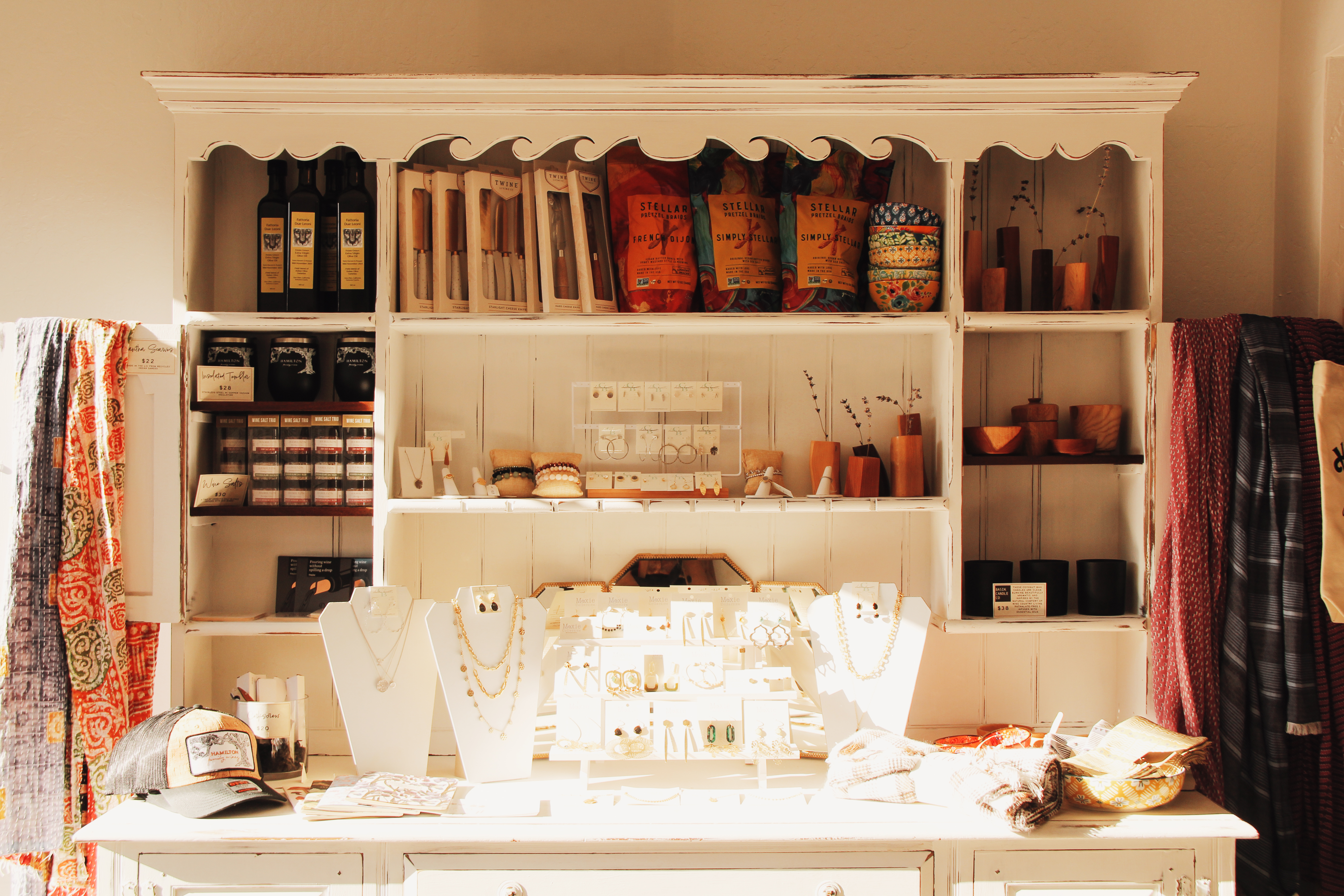 Hamilton Mercantile shelves glowing in warm holiday light.