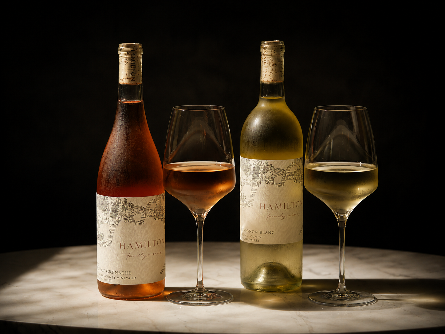Hamilton Family Wines award-winning Rosé of Grenache and Lyon Vineyard Sauvignon Blanc with glasses in the tasting room.