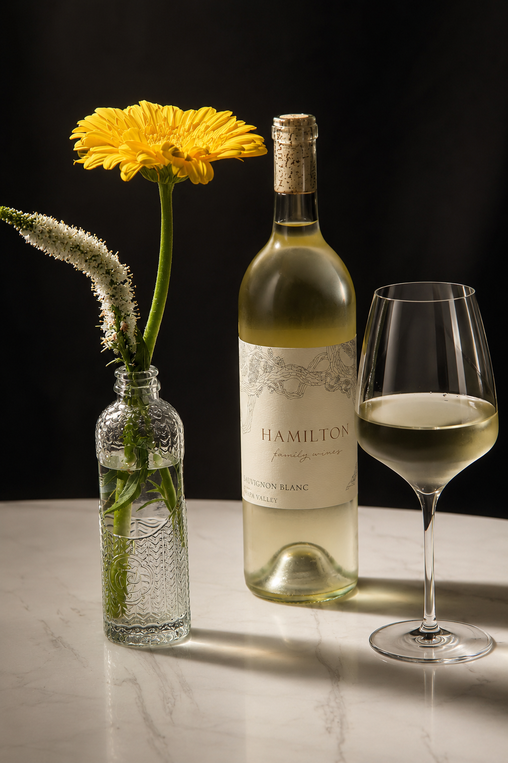 Hamilton Family Wines 2025 Lyon Vineyard Sauvignon Blanc with a glass of white wine.