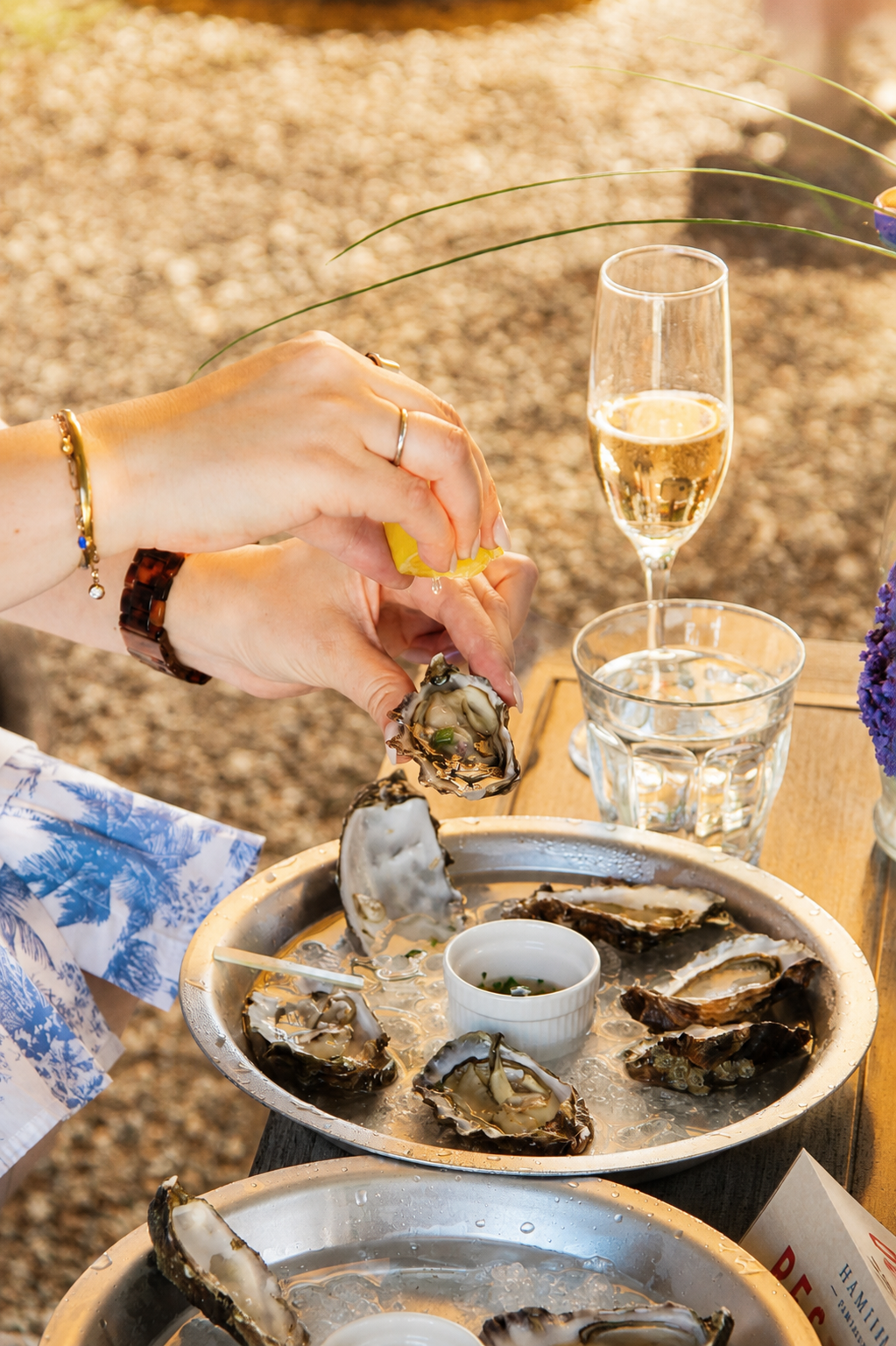 A guest enjoying oysters and Hamilton Blanc de Noir during a seasonal event in Kenwood.