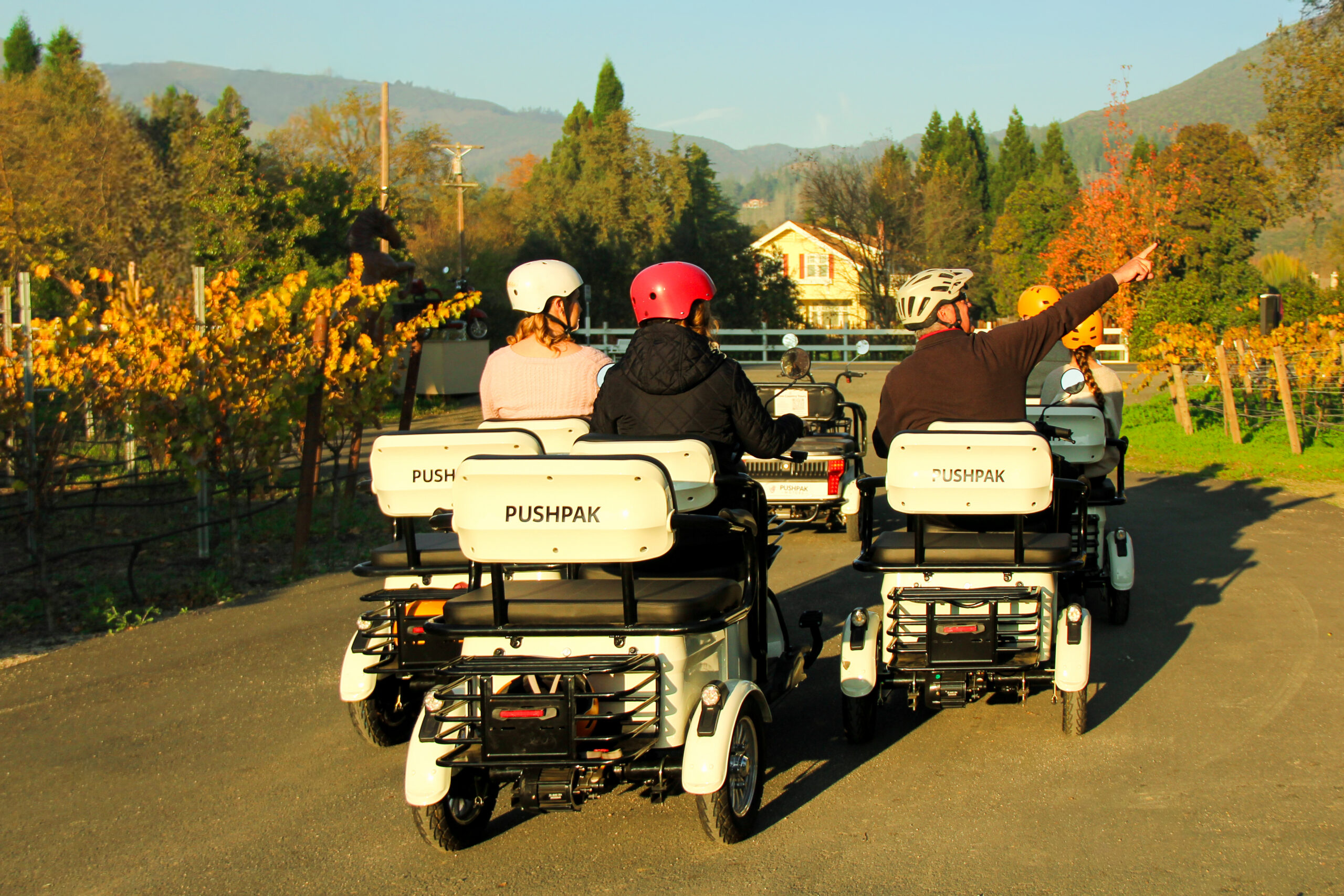 Guests riding electric trikes through Kenwood with Pushpak Wine Country Tours.