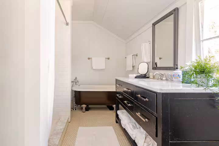 Carriage House bathroom with a separate shower and clawfoot soaking tub.